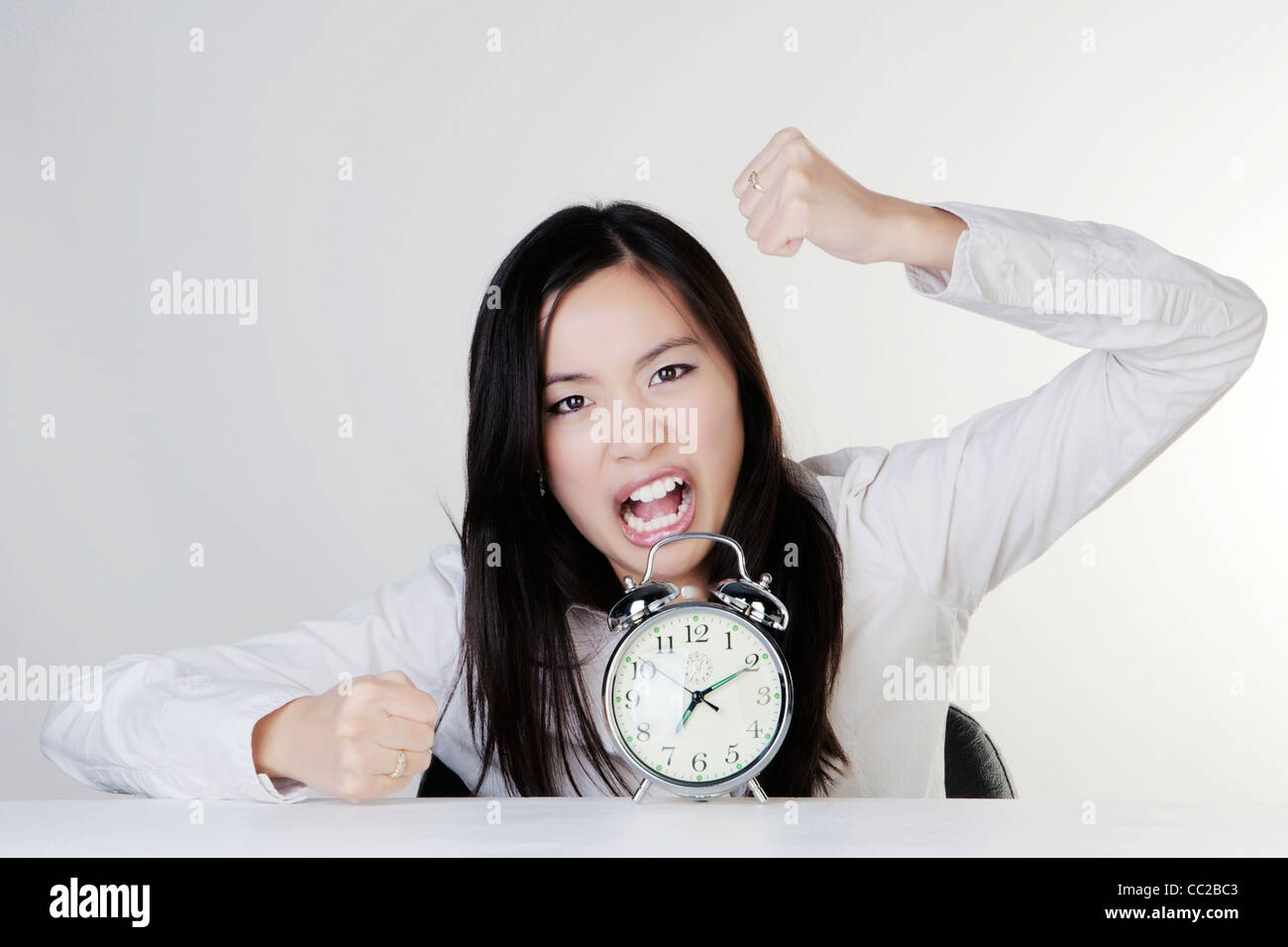 alarm clock going off and someone not happy about the noise Stock Photo