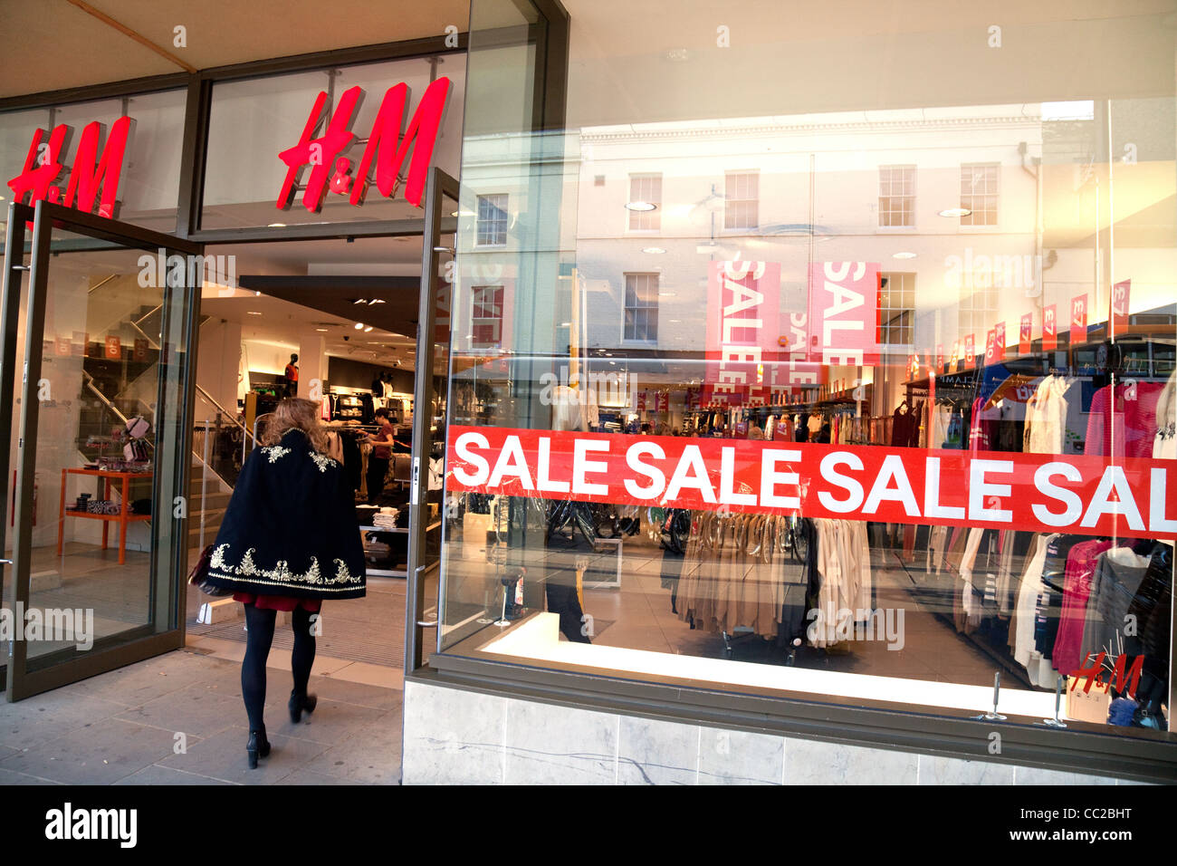 H&M store UK; A shopper entering the H&M store during the Sales Stock Photo  - Alamy
