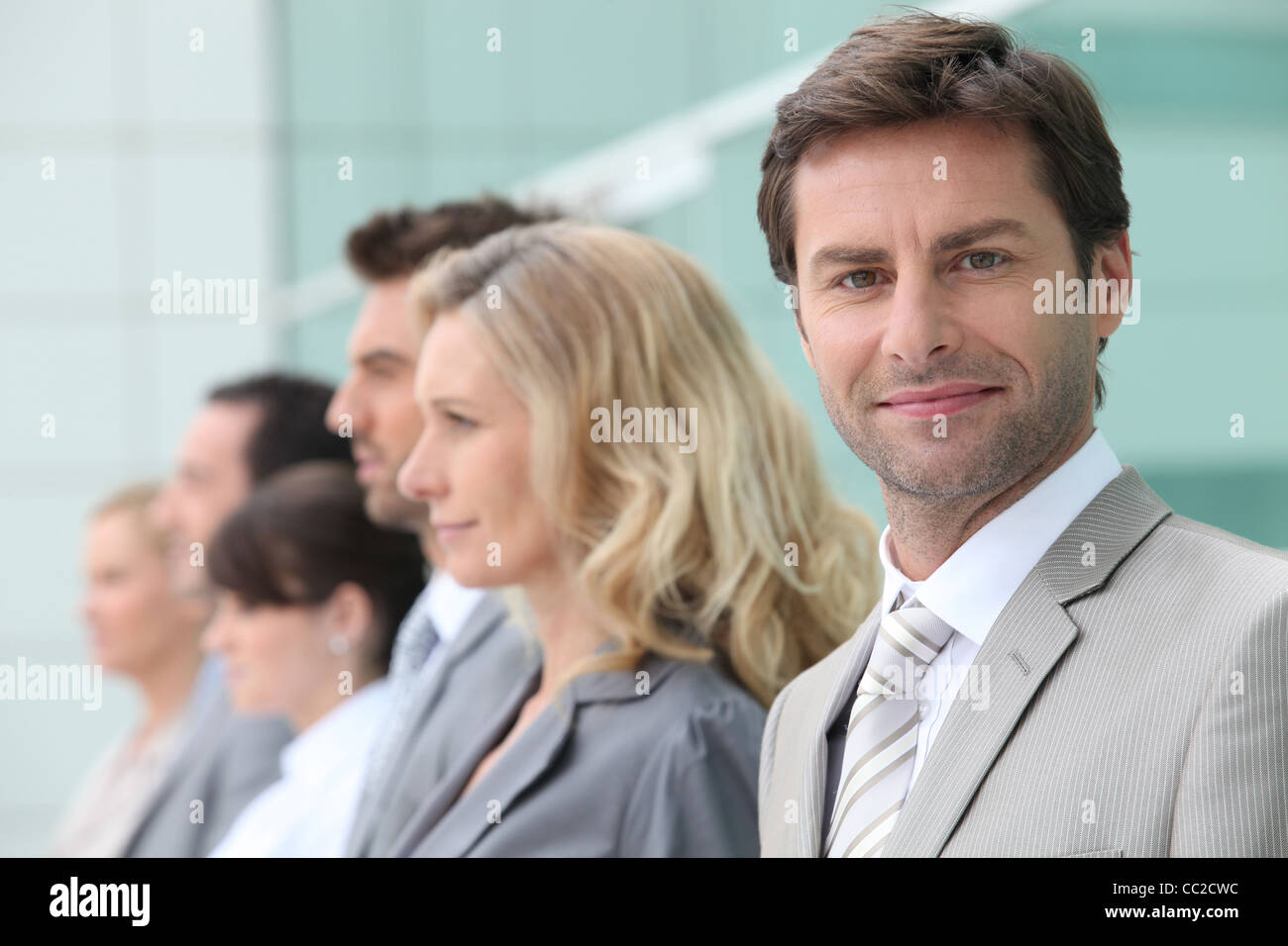 Male executive and his team Stock Photo - Alamy