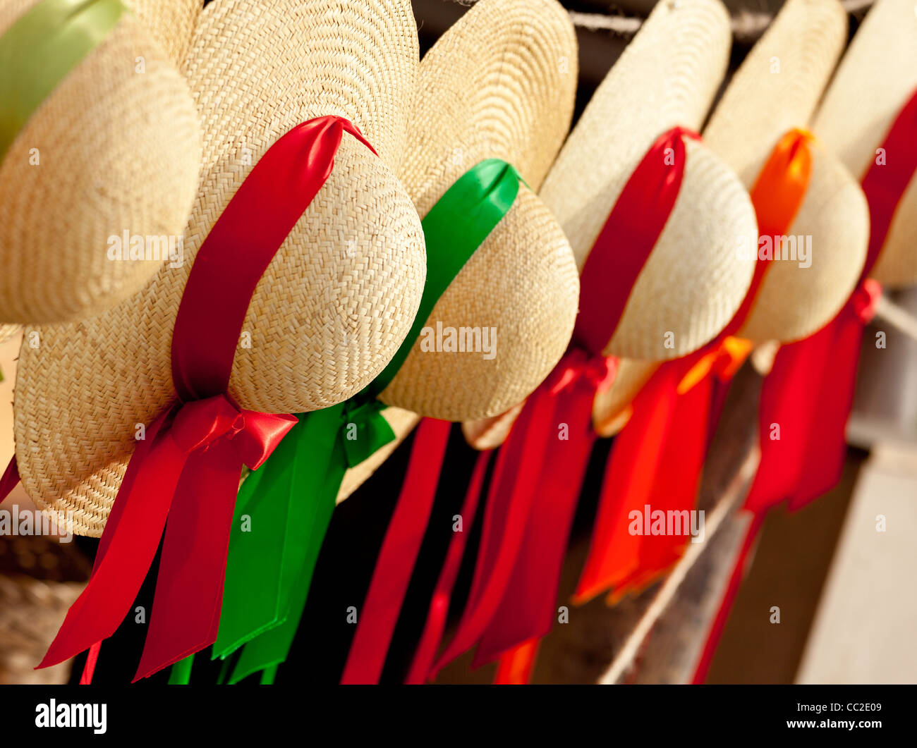 Set of straw woven hats with colorful ribbons in a row Stock Photo Alamy