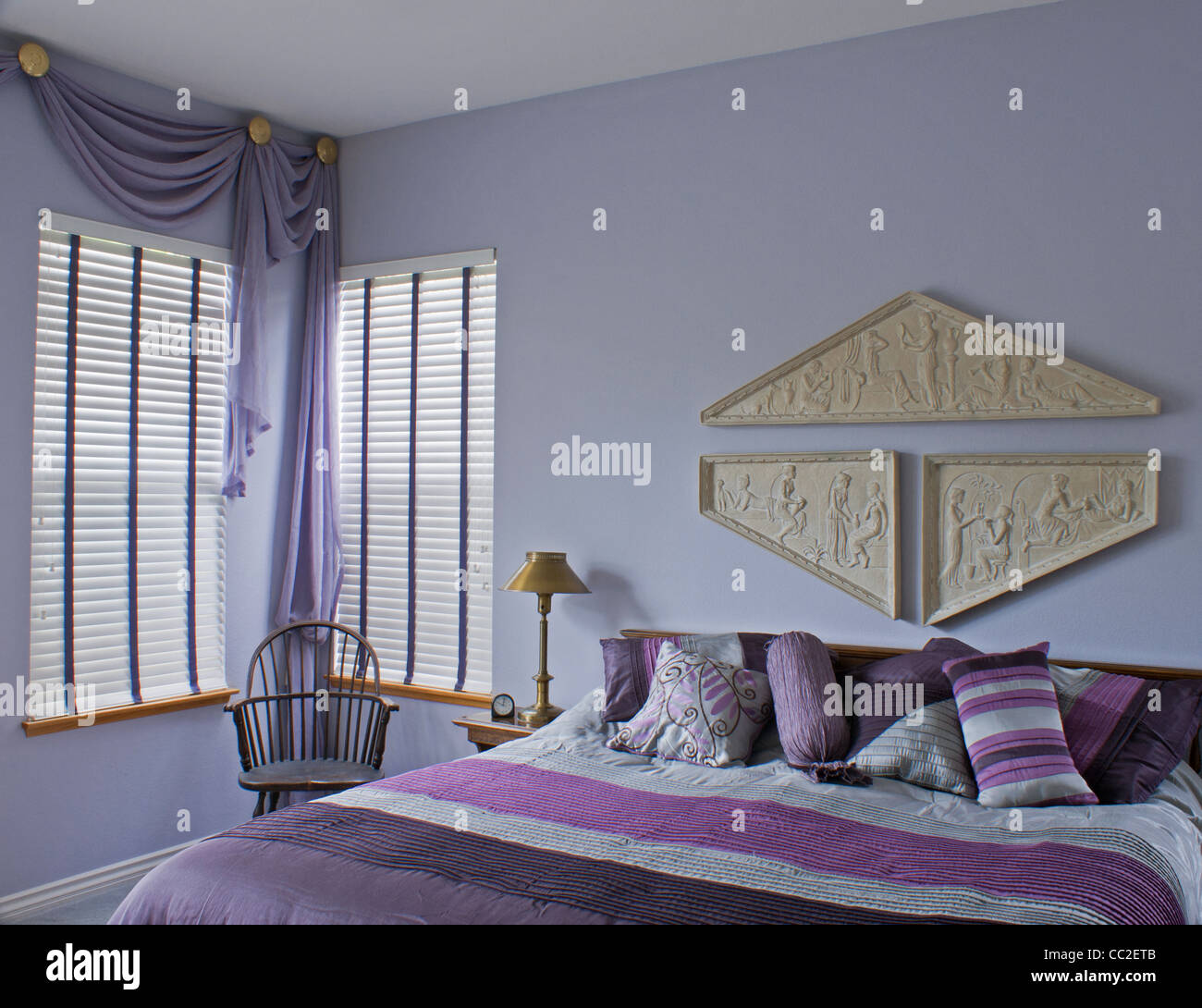 Purple plum bedroom interior showing bed, windows, walls, drapes, chair