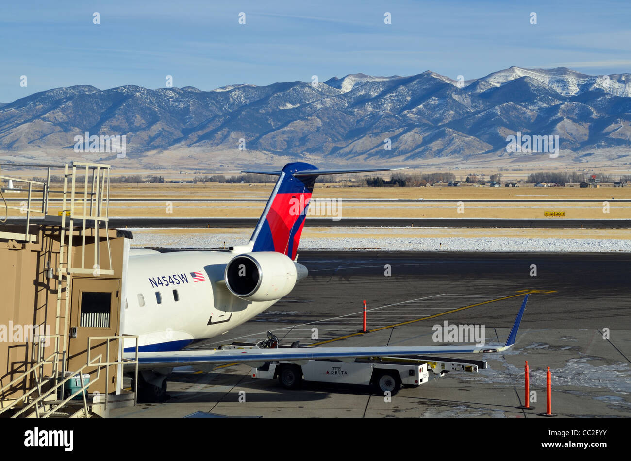 Airliner parked at the terminal, mountains as back drop. USA. Stock Photo