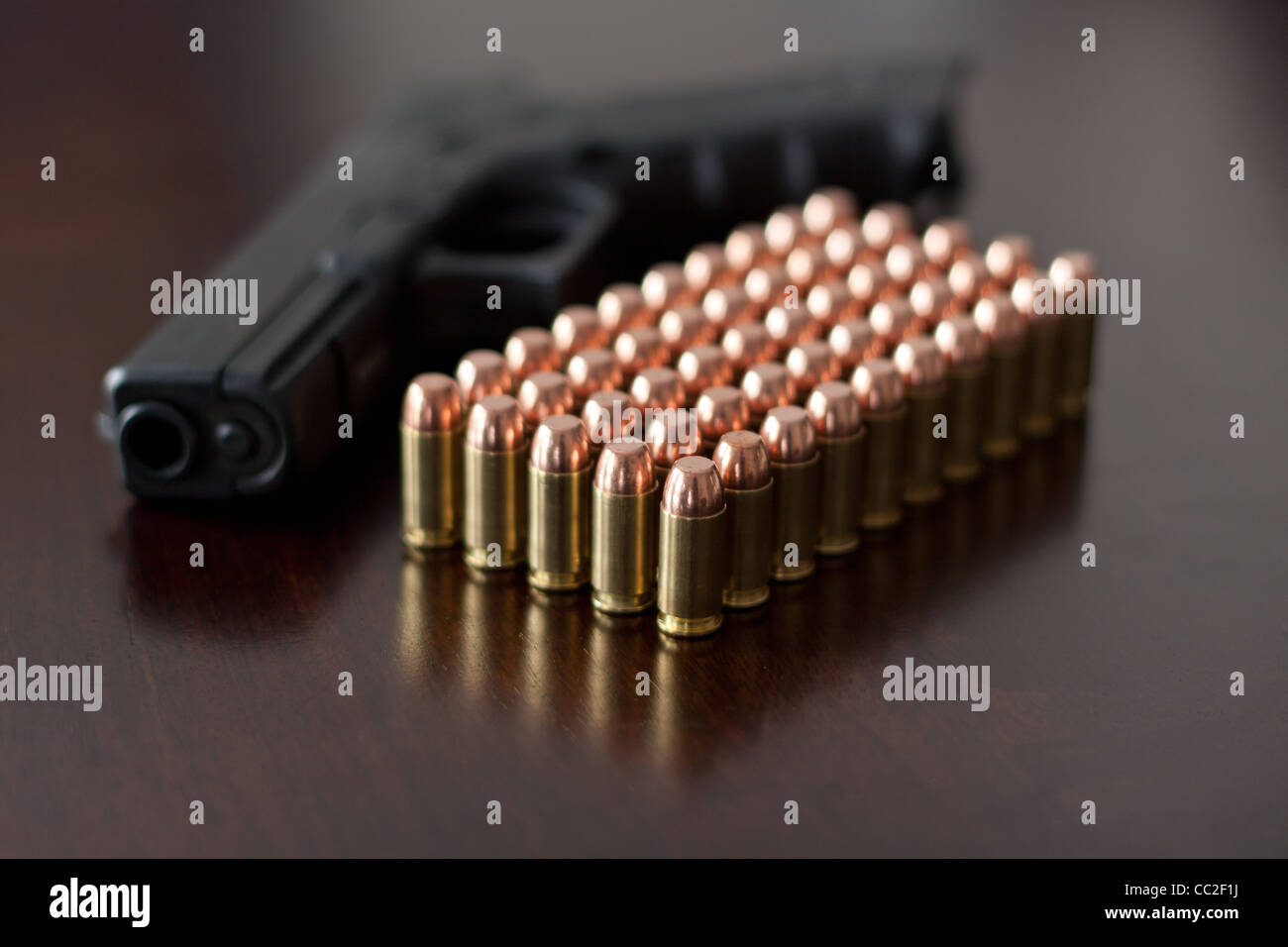 Glock 22 – 40 Caliber handgun with ammunition on a wooden surface Stock Photo