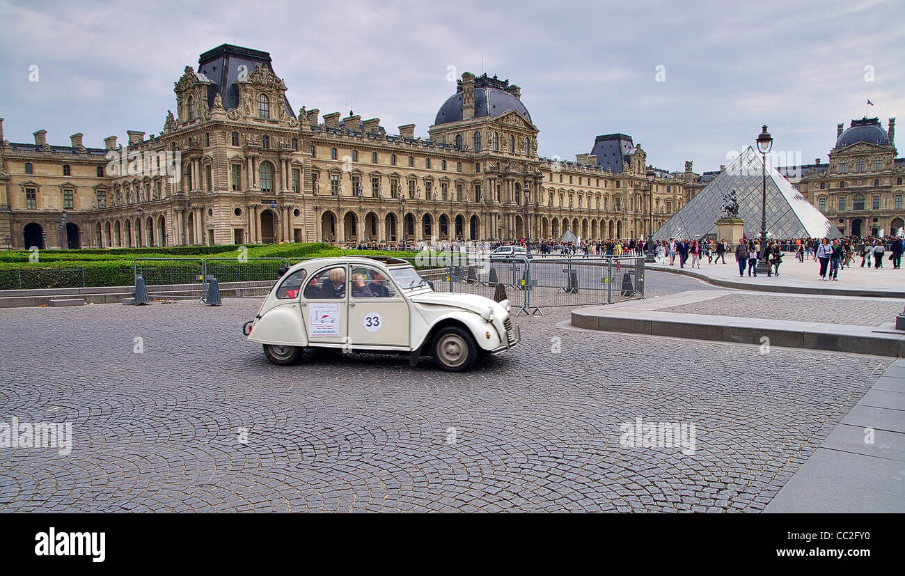 Citroen 2cv at louvre museum Paris racing in the streets nearby the pyramid Stock Photo