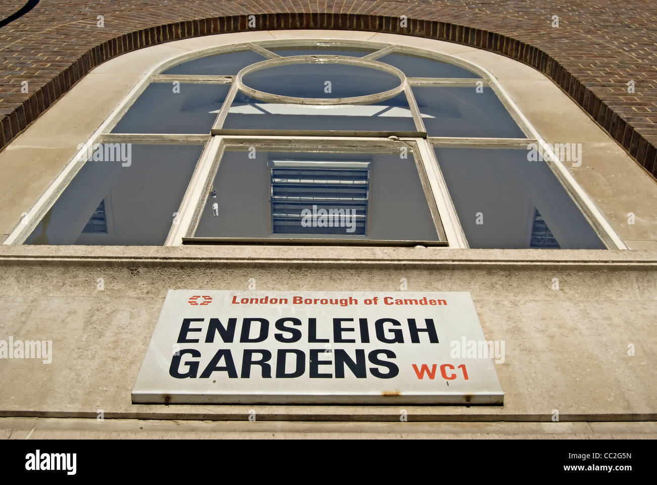 street name sign for endsleigh gardens, london, england, beneath a large window Stock Photo