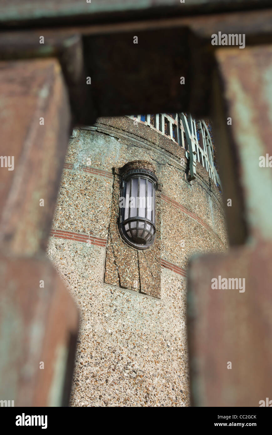 lamp on the 1933 twickenham bridge, designed by architect maxwell ayrton, seen through a stairway banister Stock Photo