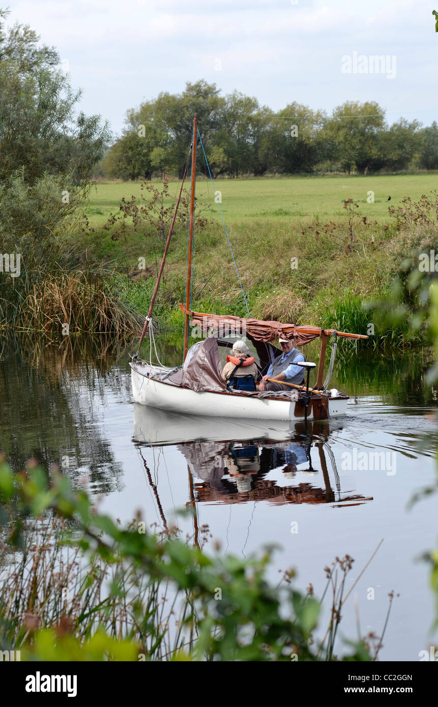 older couple boating on river great ouse fen drayton cambridgshire uk Stock Photo
