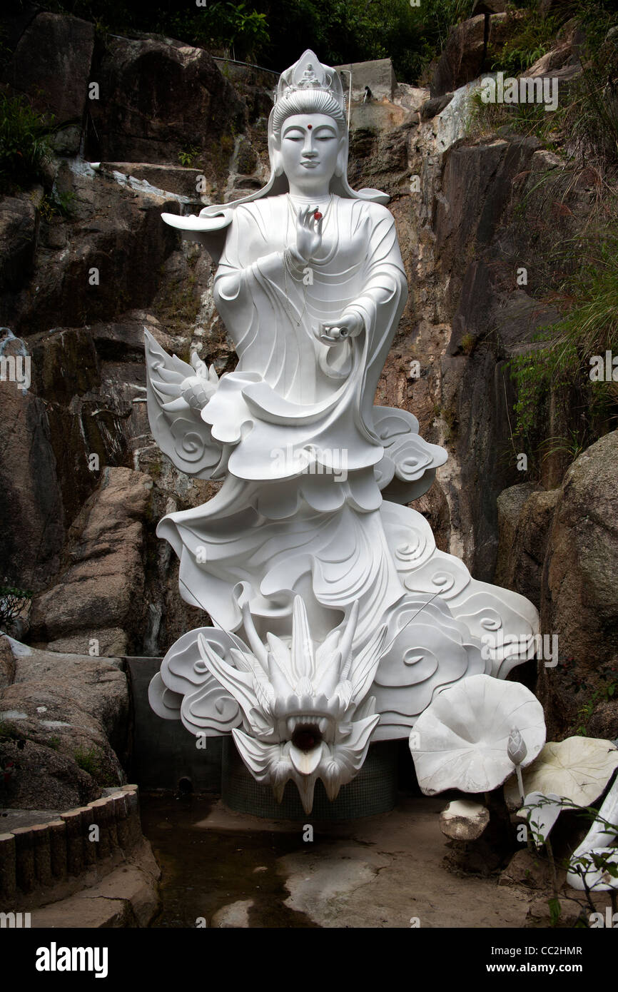 Stone statue of a Buddha in a waterfall Ten Thousand Buddhas Monastery
