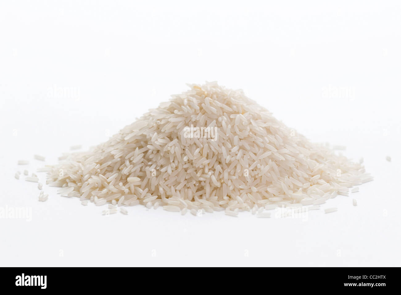 uncooked basmati rice in a small pile on a white background Stock Photo