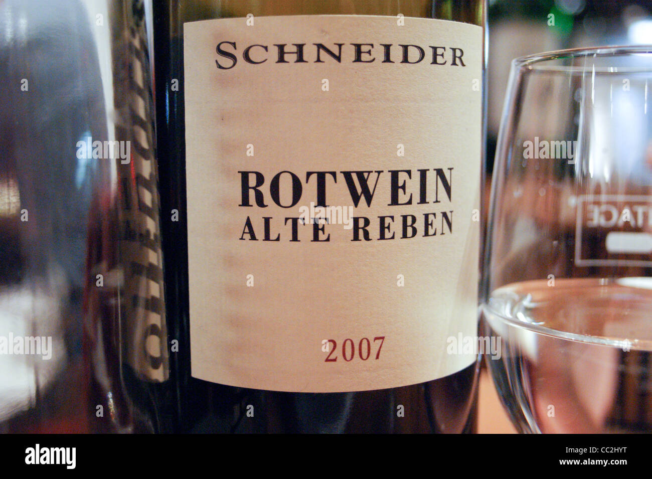 A bottle of Schneider Rotwein Alte Reben, red wine, with a wineglass, Vintage restaurant, Koln, Nordrhein-Westfalen, Germany Stock Photo