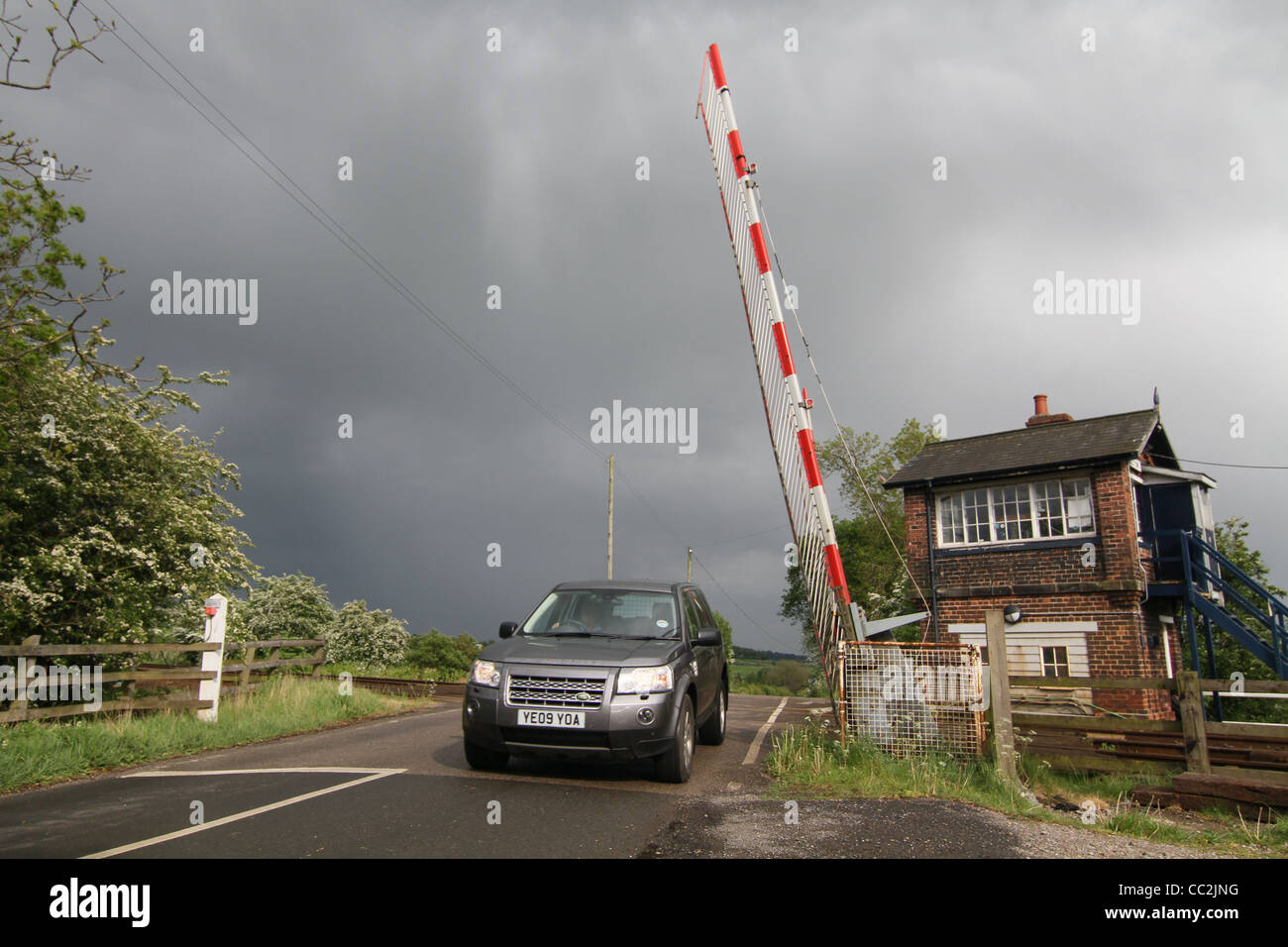 vehicle passing over a rural level crossing Stock Photo