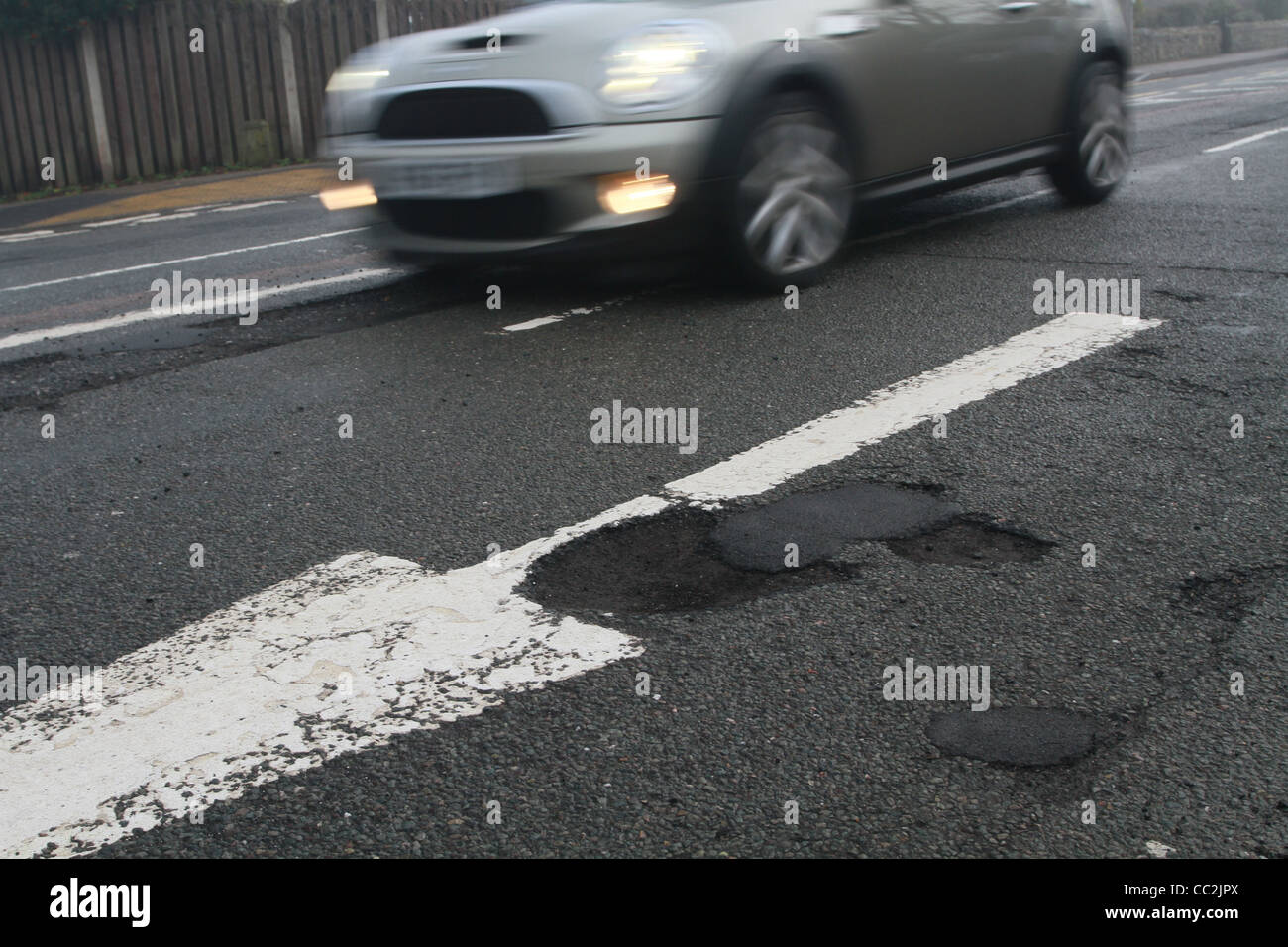 car driving past pothole Stock Photo Alamy