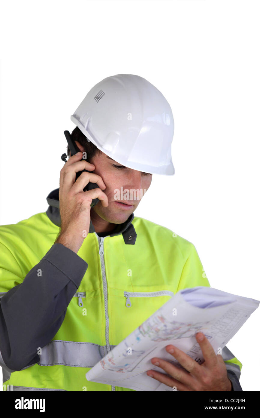 Employee Using Radio Worker with a two-way radio Stock Photo - Alamy