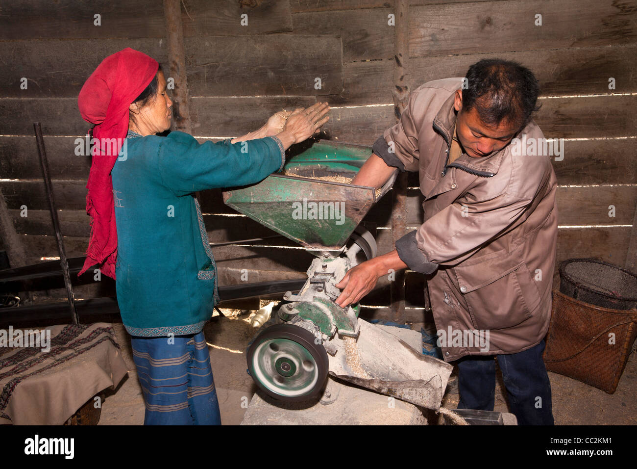 India, Arunachal Pradesh, Ziro Valley, Hari village mill, Apatani woman grinding grain with help of miller Stock Photo
