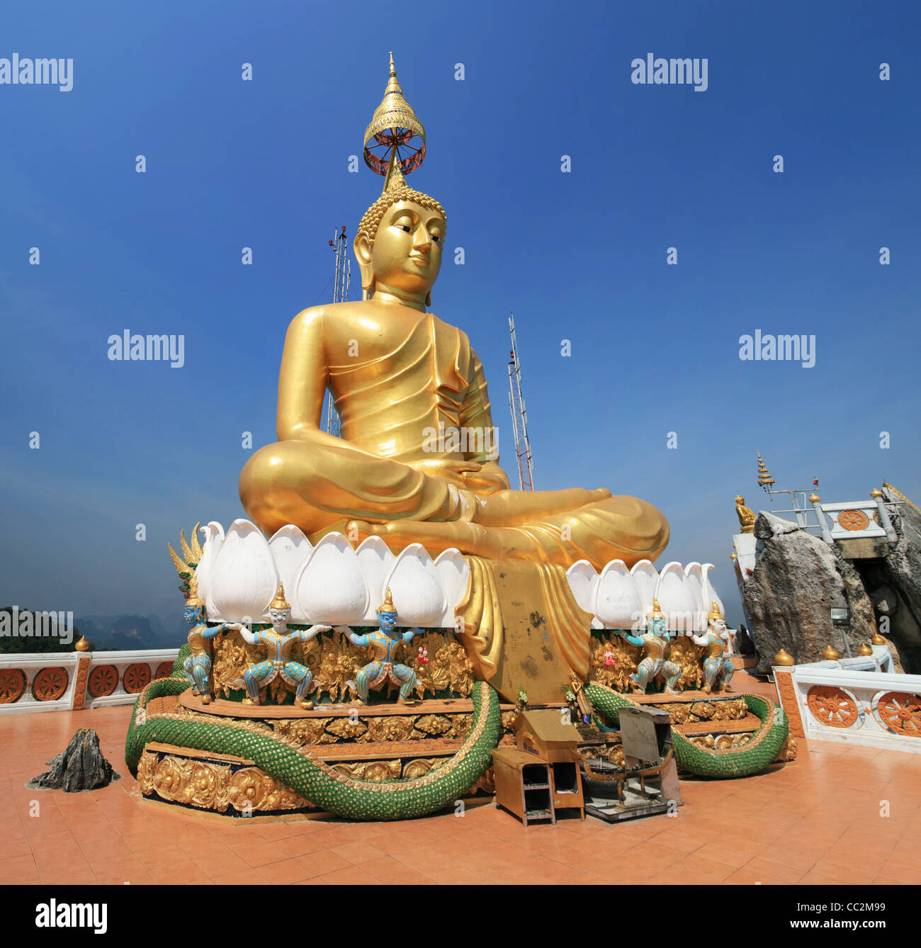 Wat Tham Seua or Tiger Cave Temple mountain top golden Buddha statue, Krabi, Thailand Stock Photo
