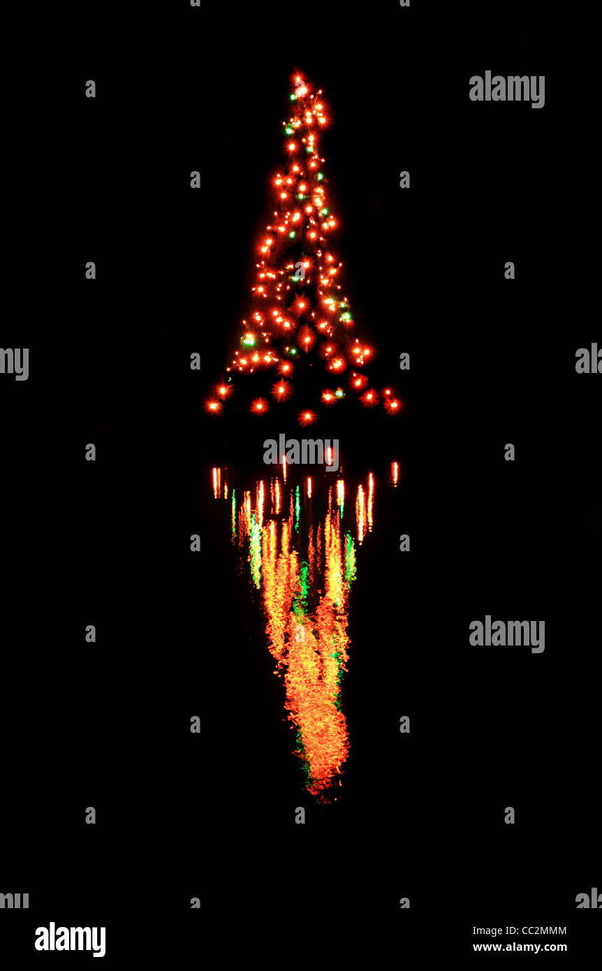 reflection of Christmas tree lights in water with black background Stock Photo