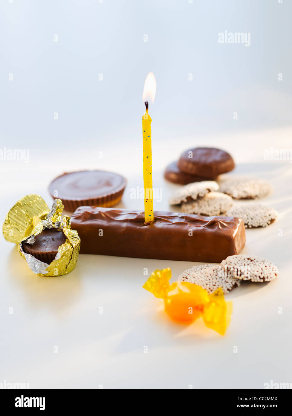 Studio shot of chocolate bars with birthday candle Stock Photo