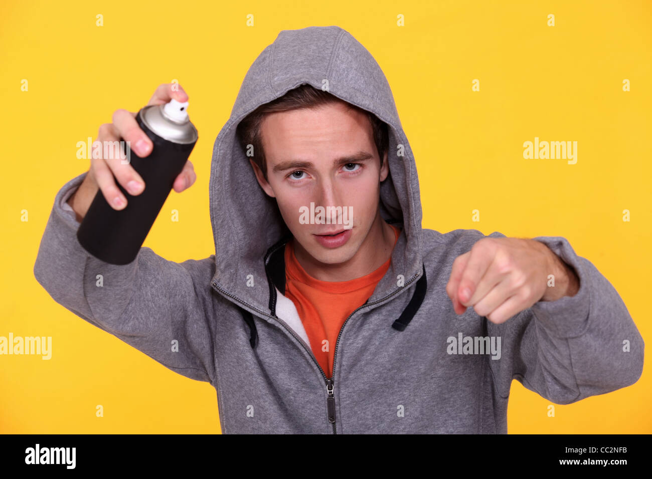 Hooded youth with paint can Stock Photo