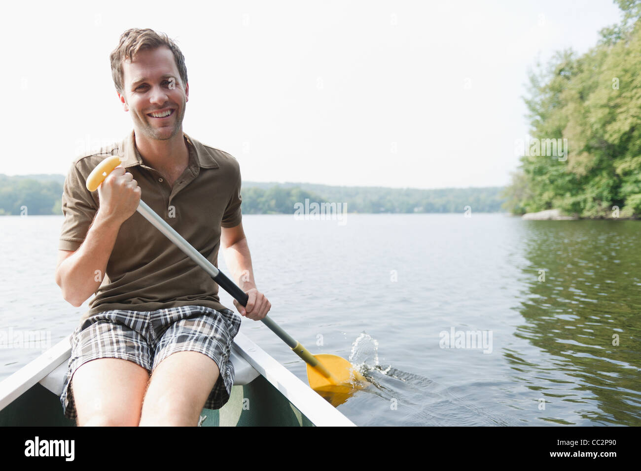 USA, New York, Putnam Valley, Roaring Brook Lake, Man rowing boat Stock