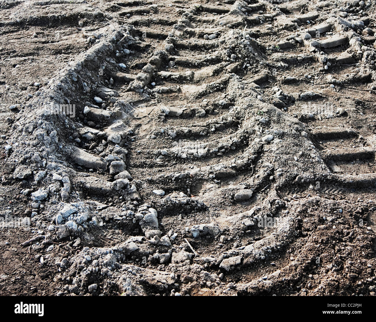 truck tire tracks in dirt at construction site Stock Photo