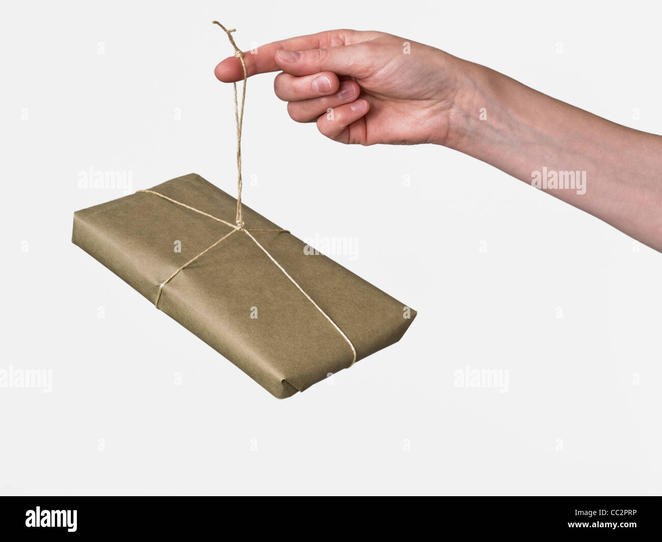 a parcel is hanging on a finger Stock Photo - Alamy