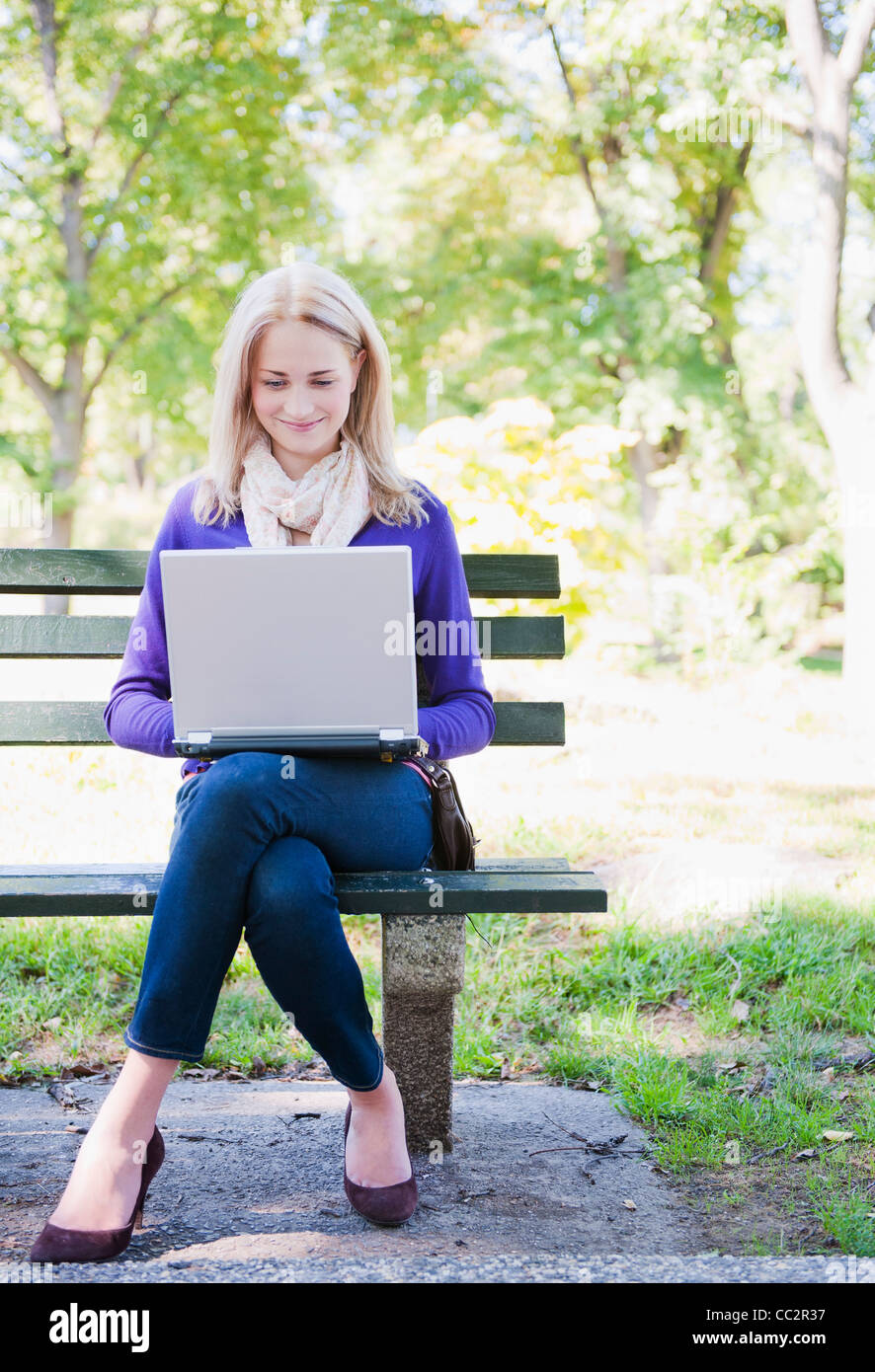 Young woman in park laptop hi-res stock photography and images - Alamy