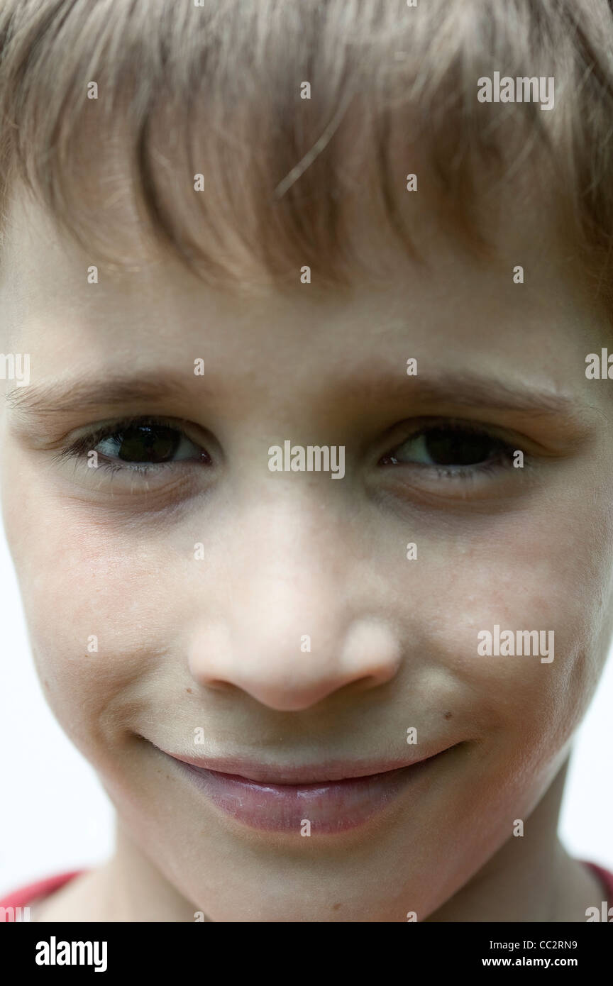 Close-up on young boy smiling at camera Stock Photo - Alamy