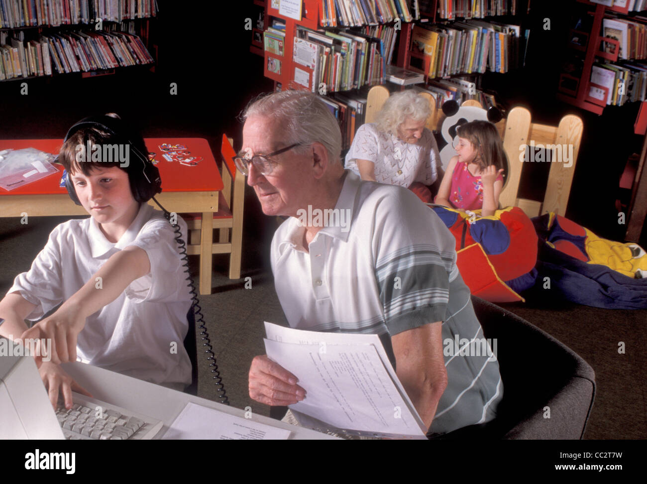 grandparents with their grandchildren in public library Stock Photo