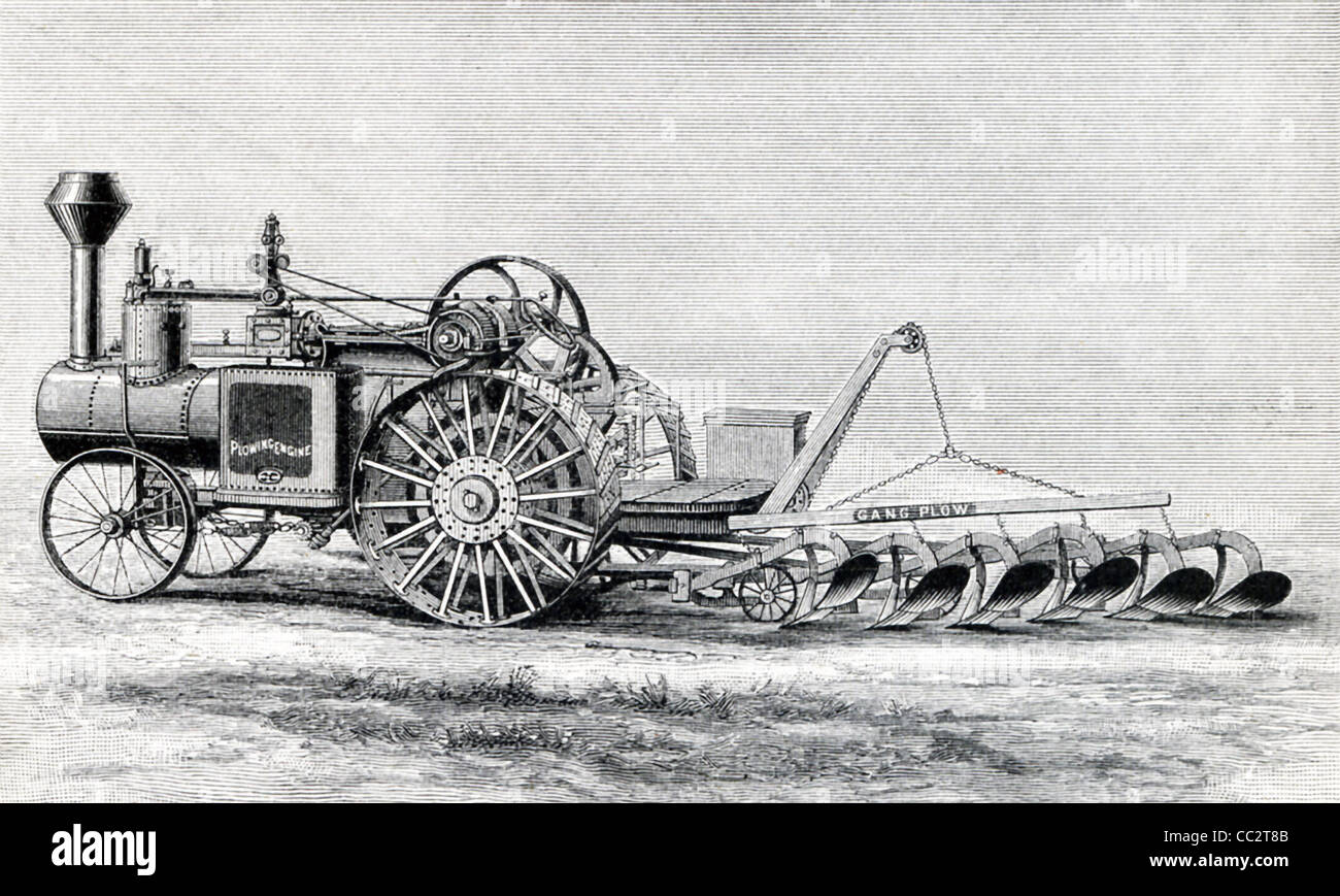 This gang plow is pulled by a steam engine, on the side of which are the words 'Plowing Engine.' Stock Photo