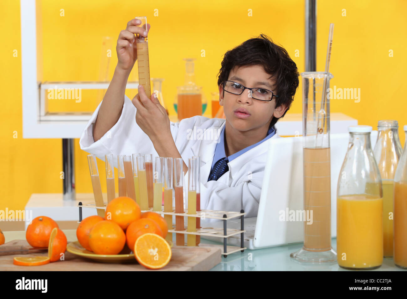 Little boy conducting experiment on orange juice Stock Photo Alamy