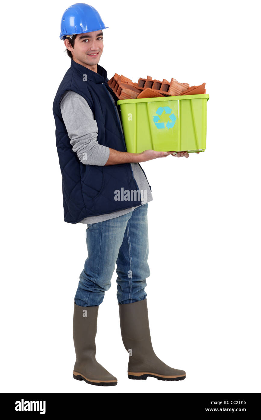 Young tradesman taking out the recycling Stock Photo