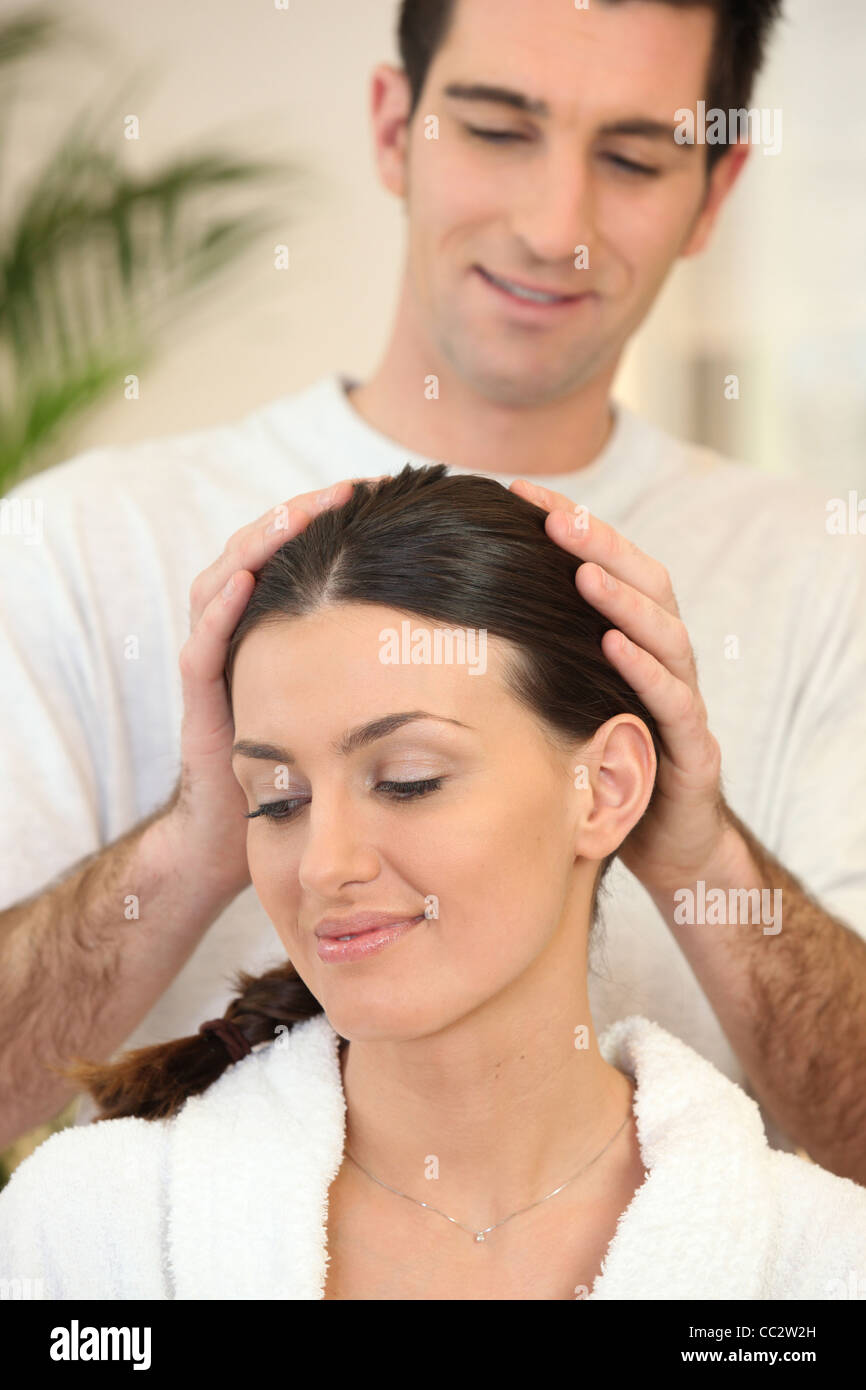 Man giving his wife a head massage Stock Photo