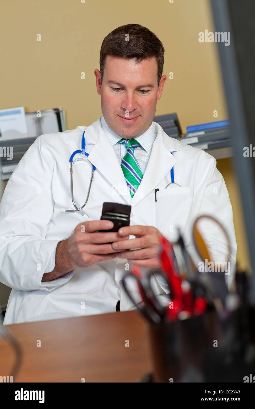 USA, Arizona, Phoenix, Male doctor text messaging Stock Photo