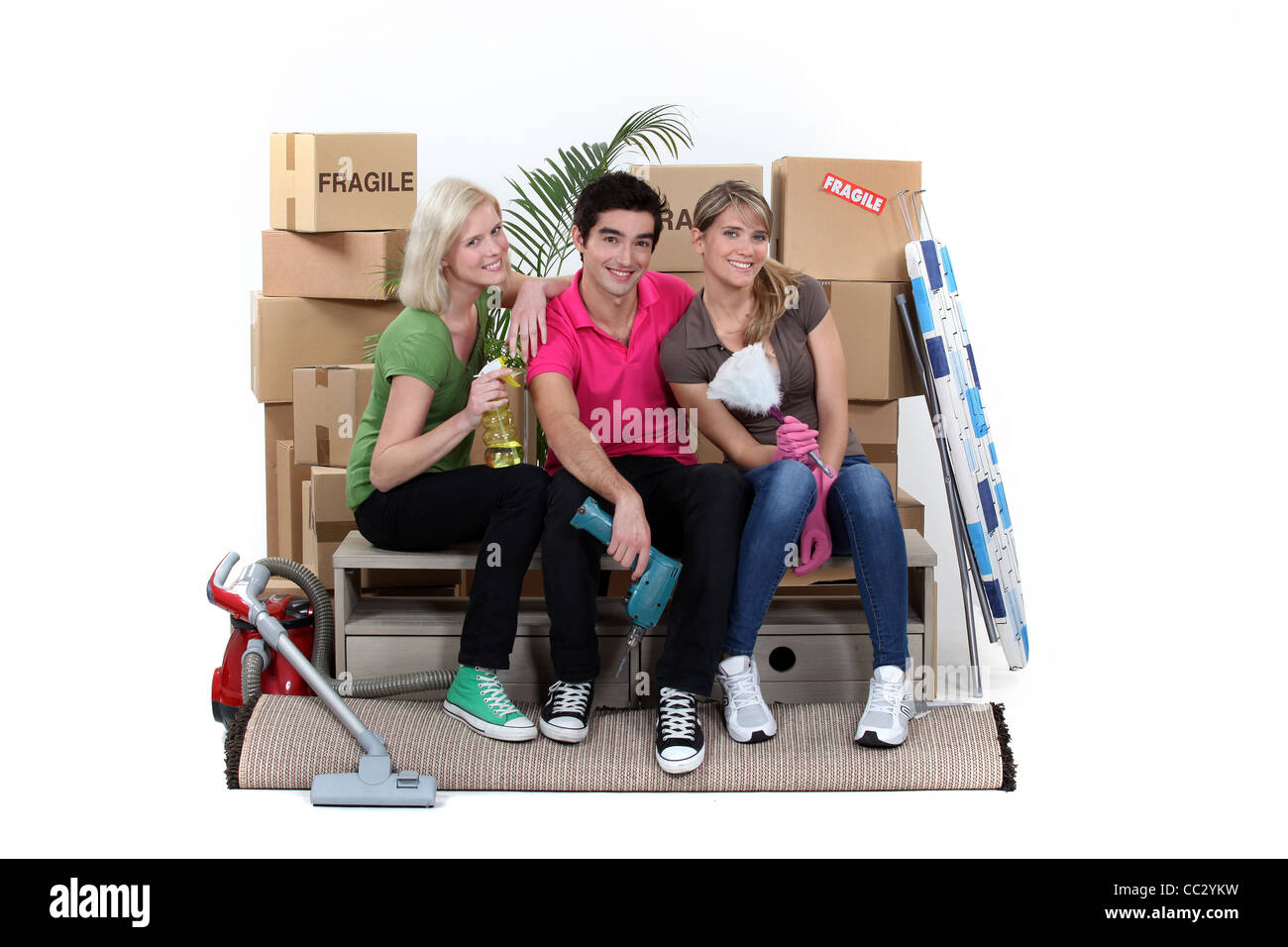 Three house-mates moving Stock Photo - Alamy