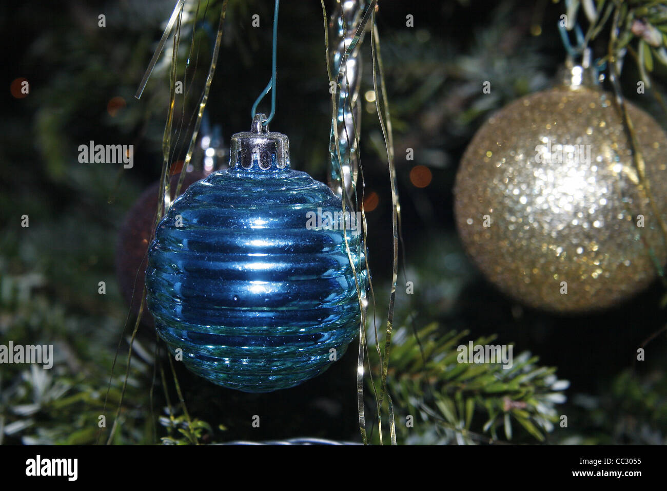 baubles and tinsel hanging on christmas tree Stock Photo - Alamy
