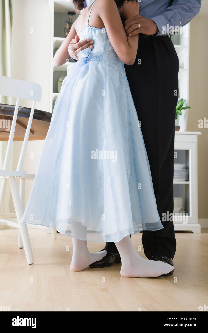 USA, California, Los Angeles, low section of Father and Daughter (10-11) dancing in kitchen Stock Photo