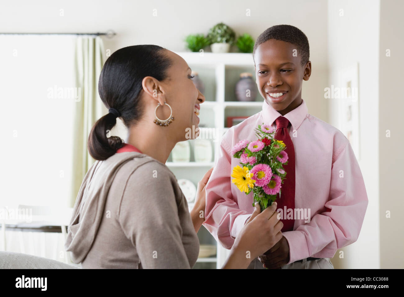 USA, California, Los Angeles, Son (12-13) giving flowers to Mother Stock Photo