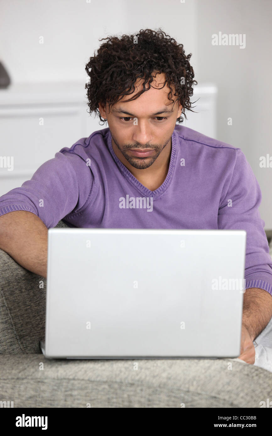 Man using computer at home Stock Photo - Alamy