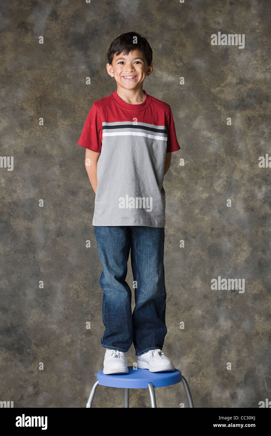 Studio portrait boy on stool hi-res stock photography and images - Alamy