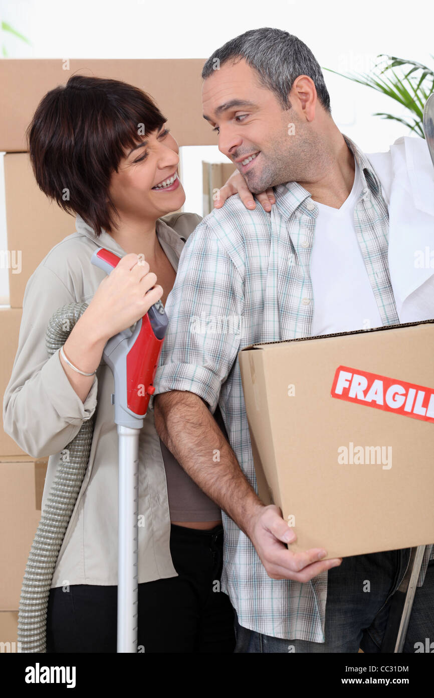Couple moving into new home with boxes marked fragile Stock Photo - Alamy