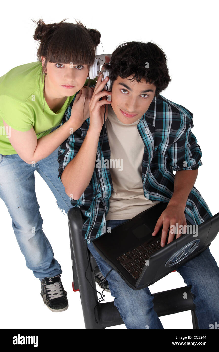 Teenagers sharing headphones Stock Photo