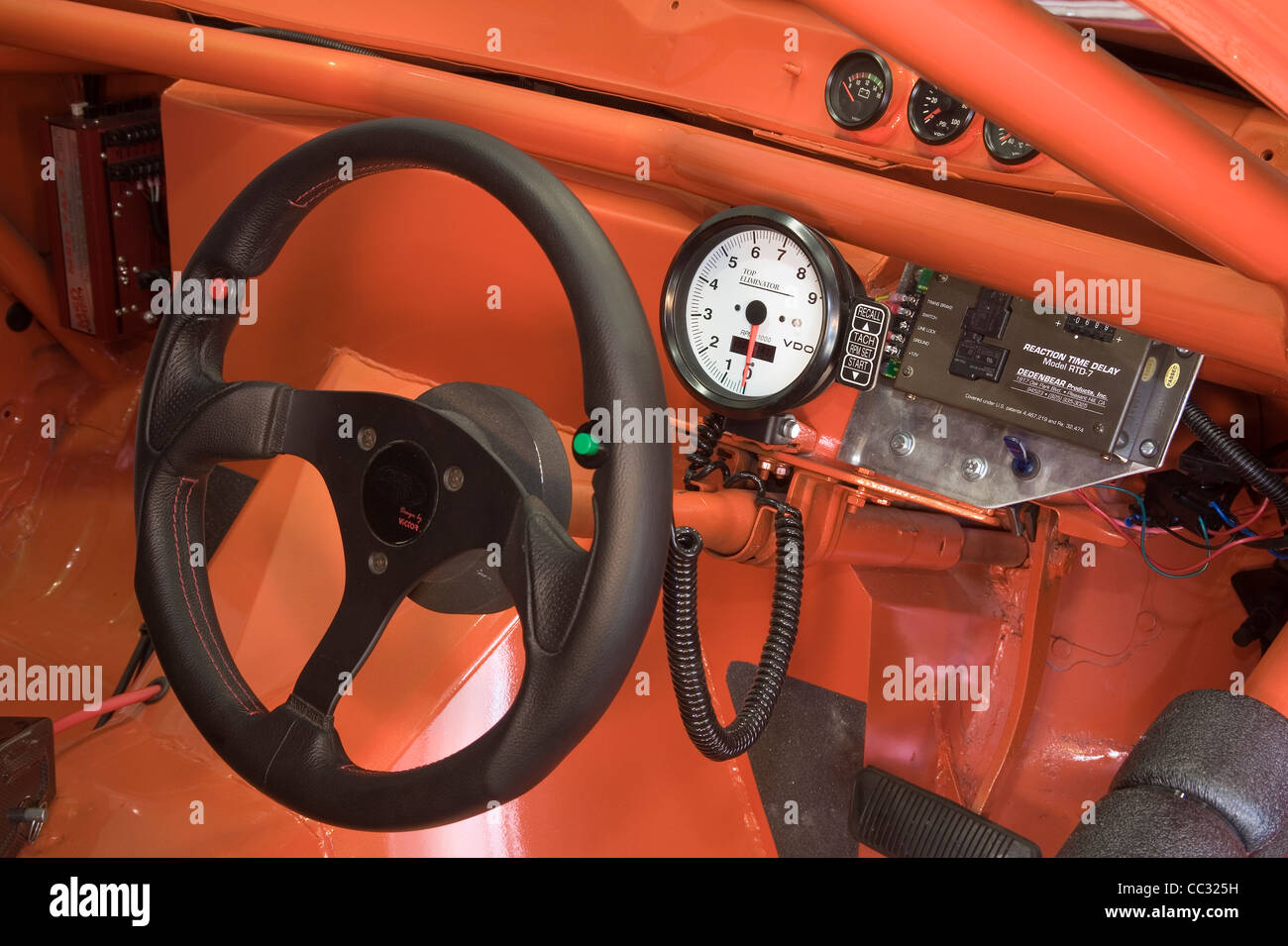 Steering wheel and custom dash fascia with tacho tachometer in a race