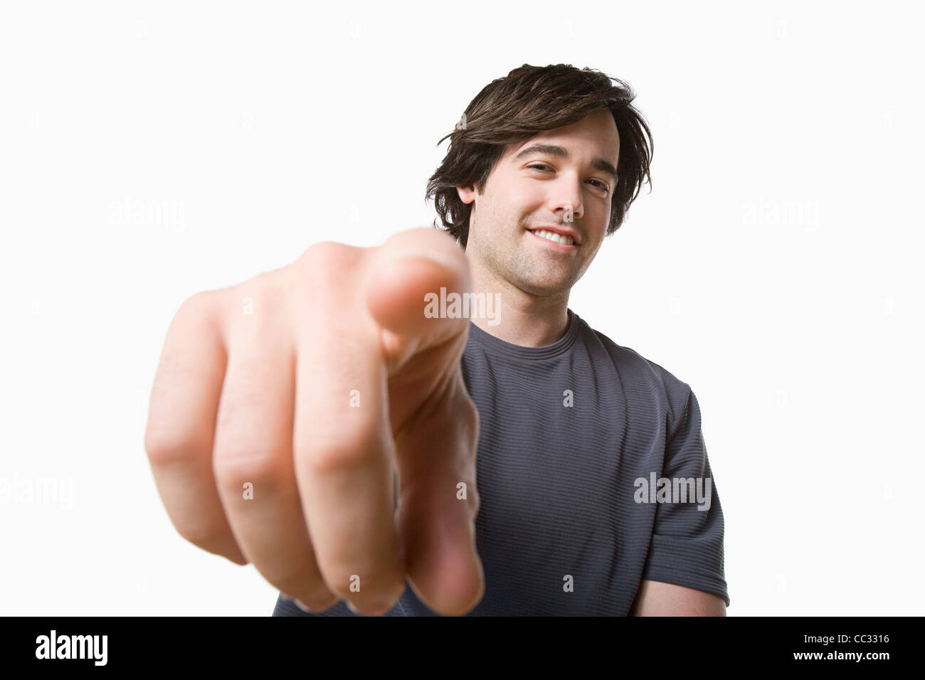 Studio portrait of young man pointing Stock Photo Alamy