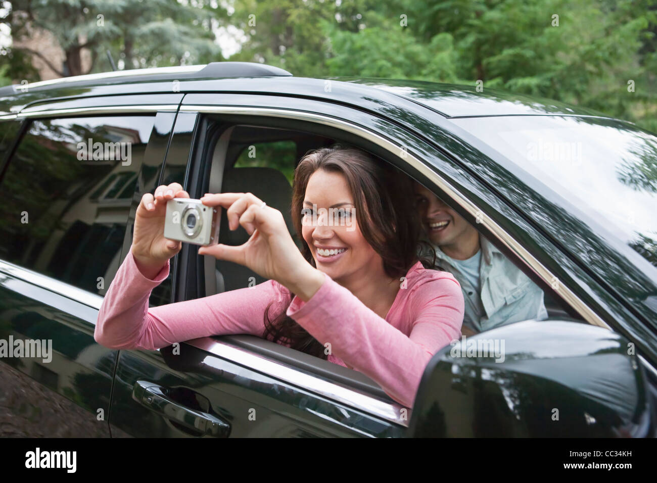 USA, New Jersey, Woman taking pictures from car Stock Photo