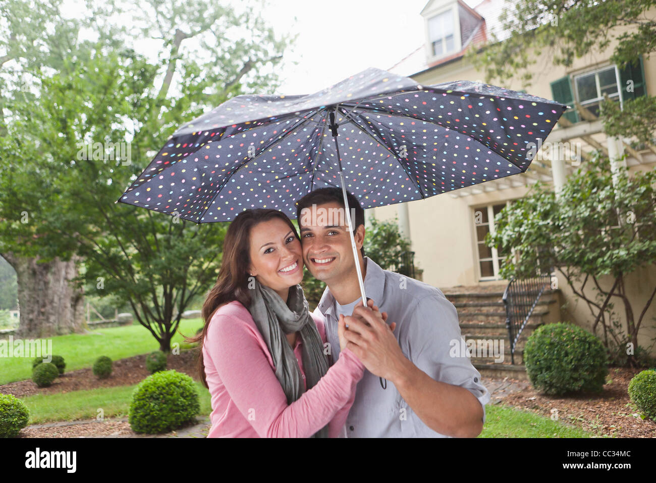 USA, New Jersey, Portrait of couple holding umbrella Stock Photo