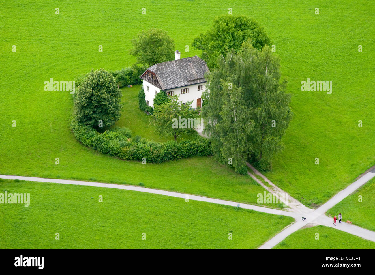 Sweet home on the center of meadow near Salzburg Stock Photo