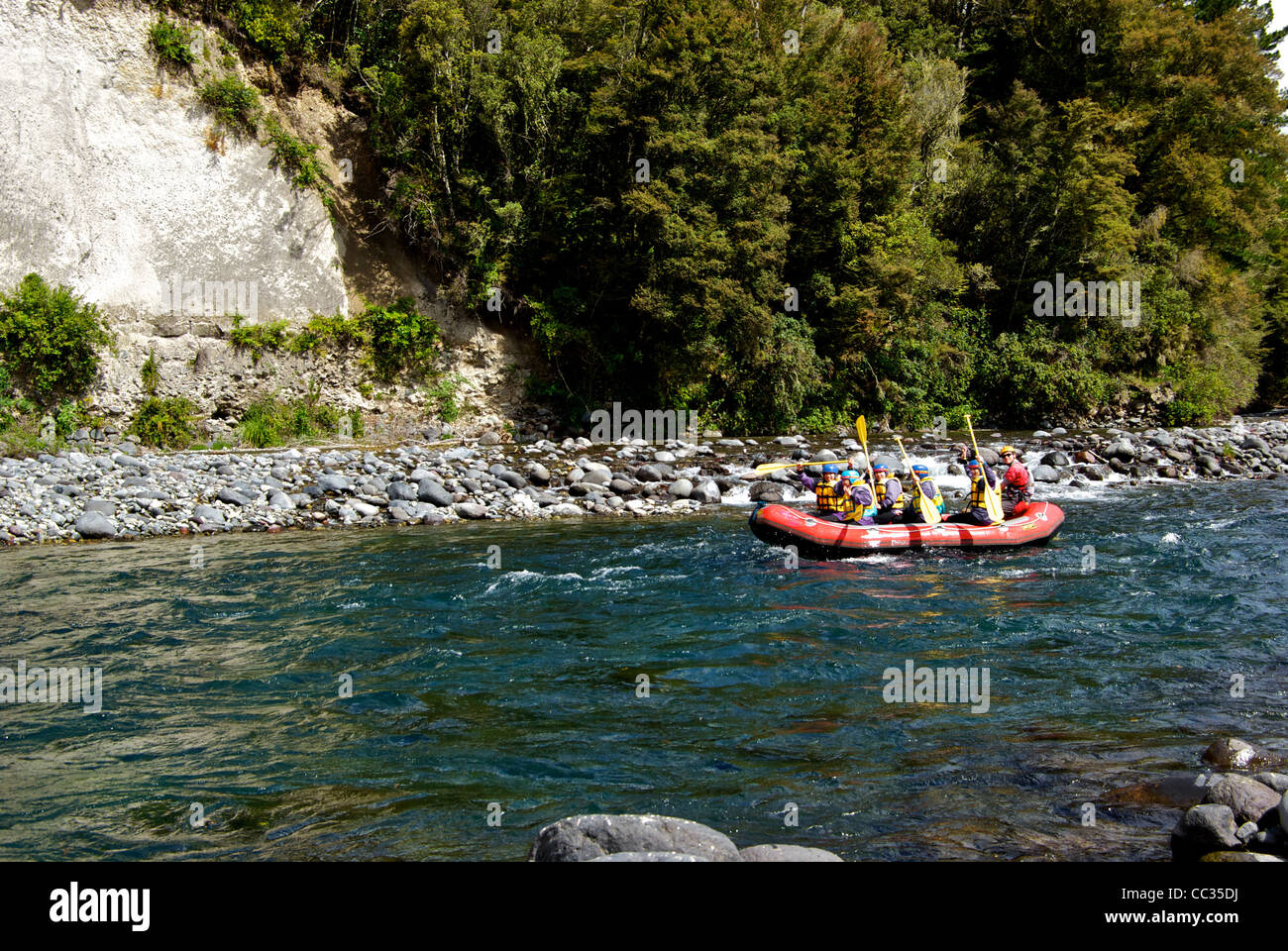 Nz Rib Raft Group Asian women guide paddling inflatable raft Tongariro River Lake ...