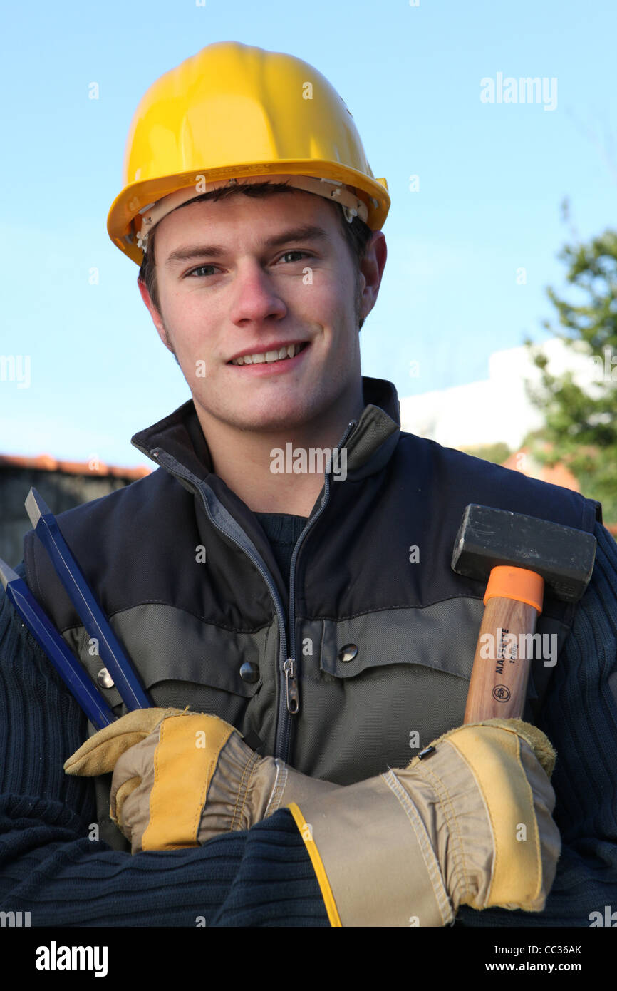 Worker holding hammer and chisel Stock Photo - Alamy