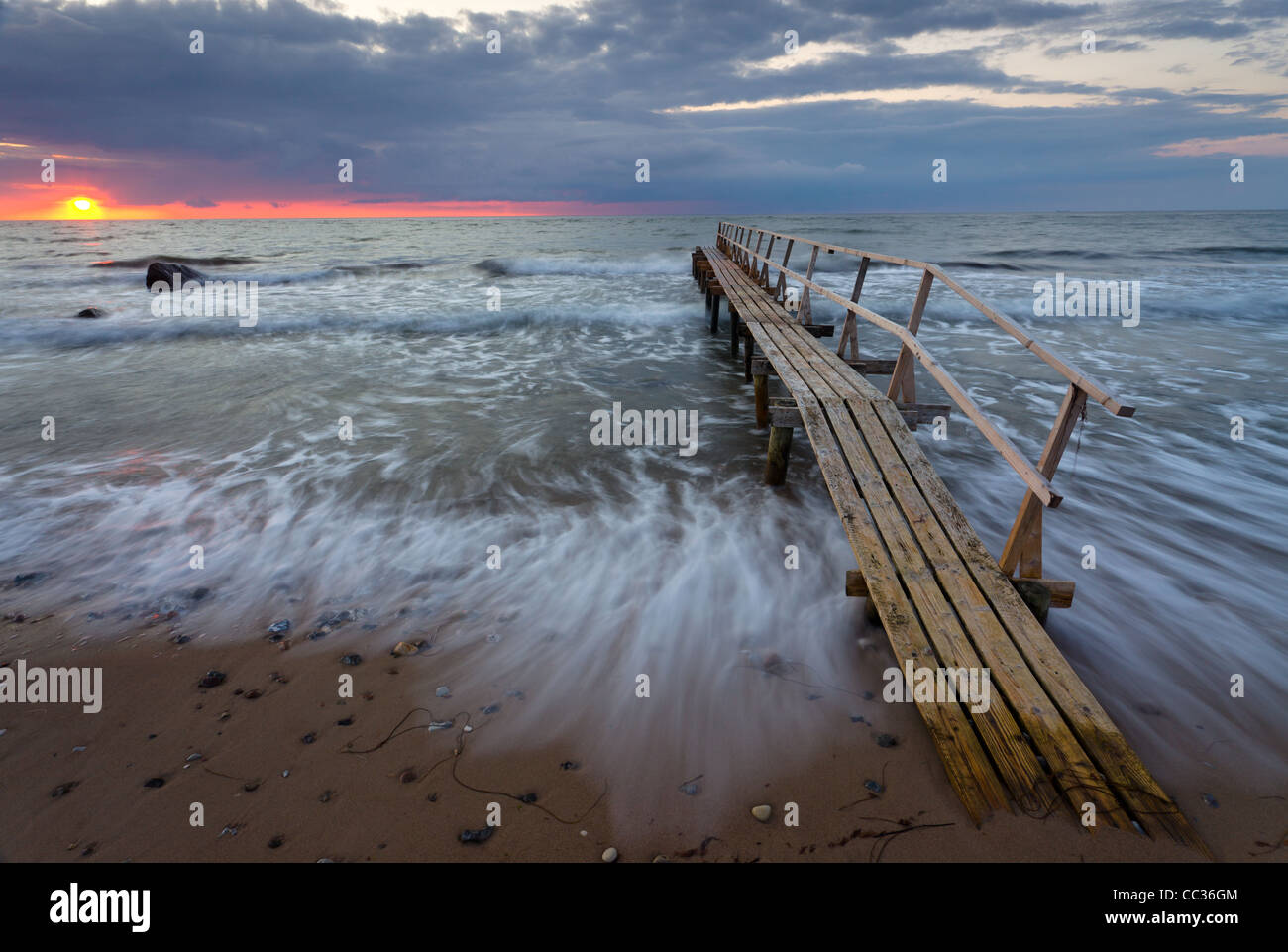 "Badebro" (bathing bridge), or a bathing jetty, at sunset on Smidstrup Strand near Gilleleje, North Zealand, Denmark. Stock Photo
