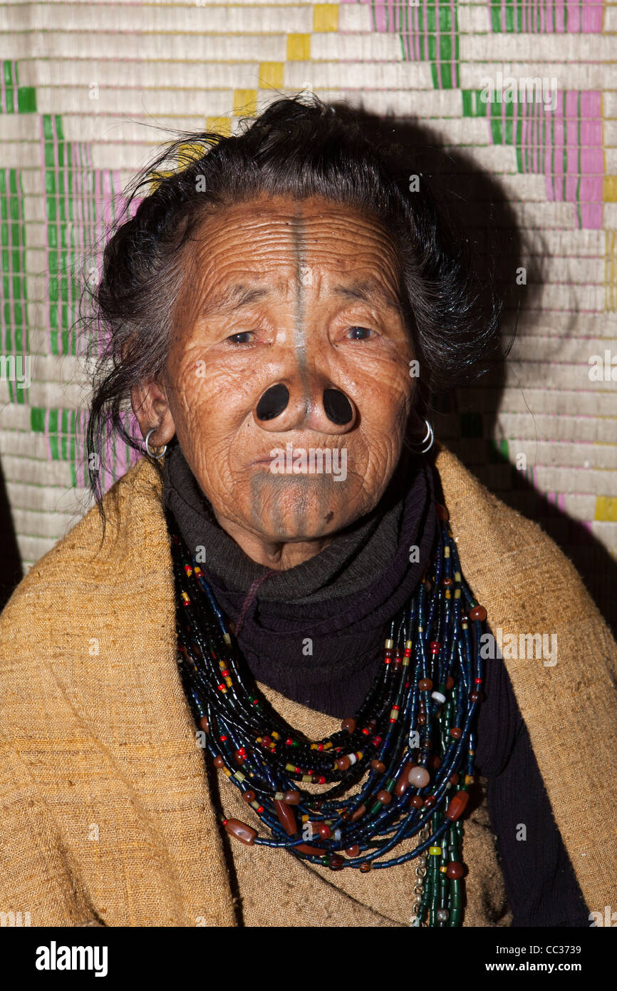 India, Arunachal Pradesh, Ziro Valley, Mida, face of older tattooed Apatani woman with facial tattoos and nose plugs Stock Photo